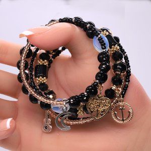 Spectacular black memory wire bracelet with 4 pendants and 6 strands.